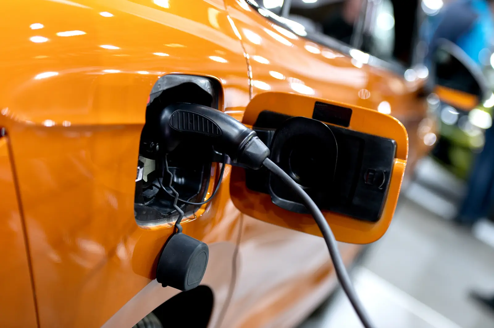 Electric vehicle charging cable plugged into a car's charging port